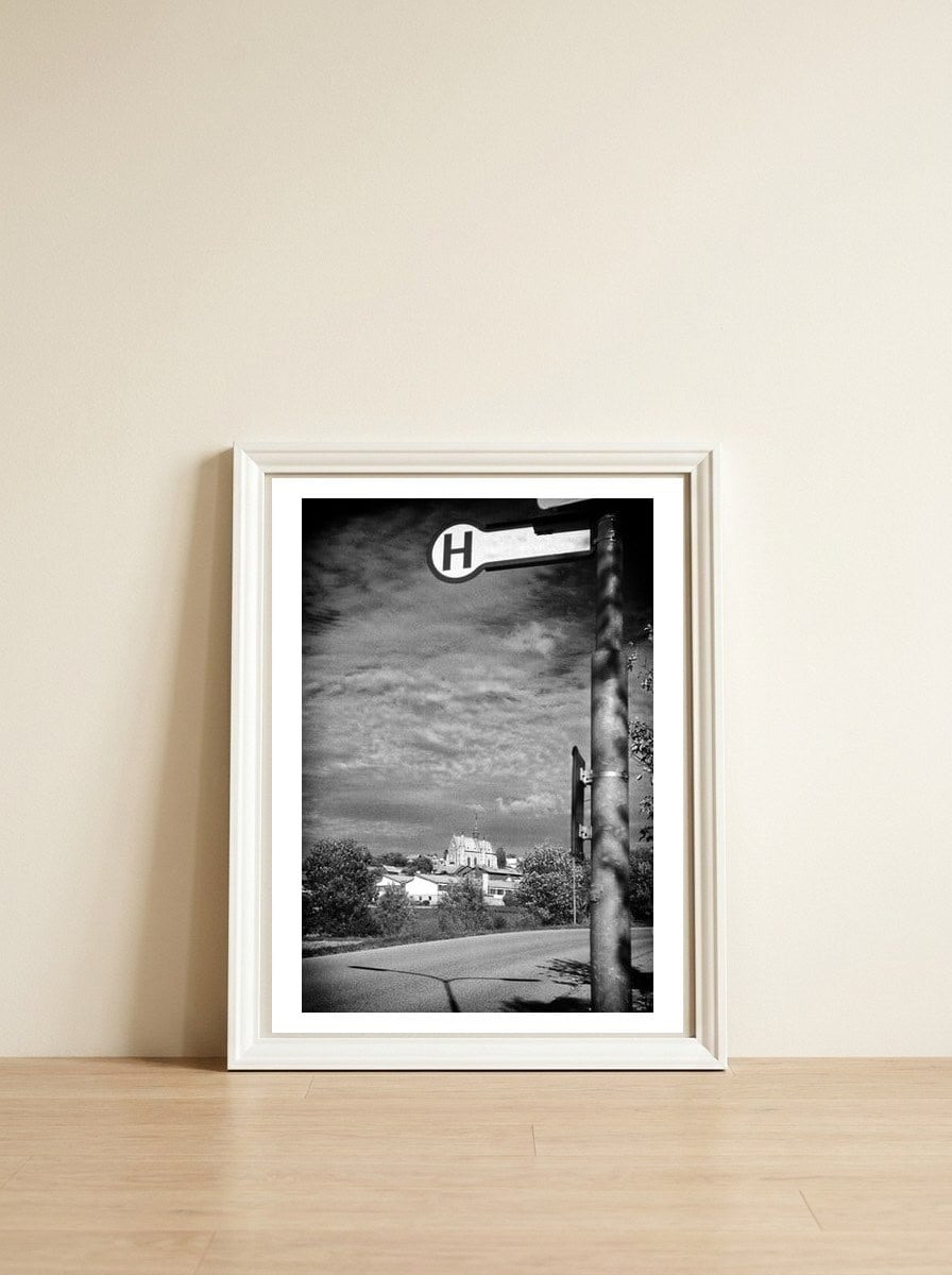 Bus station — framed, leaning against the wall