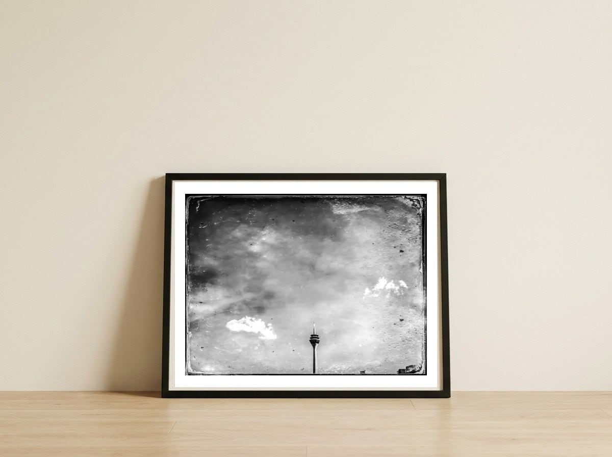 Tower in the sky — framed, leaning against the wall