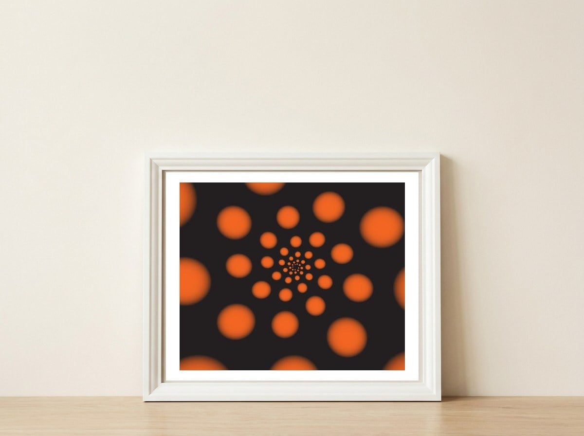 Orange Spiral Dots — framed, leaning against the wall