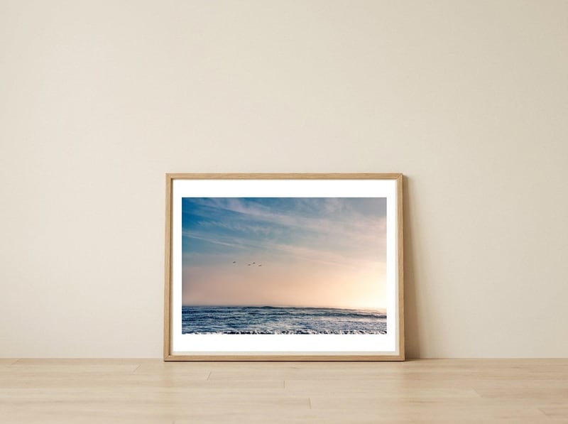 Pelican Sunset — framed, leaning against the wall
