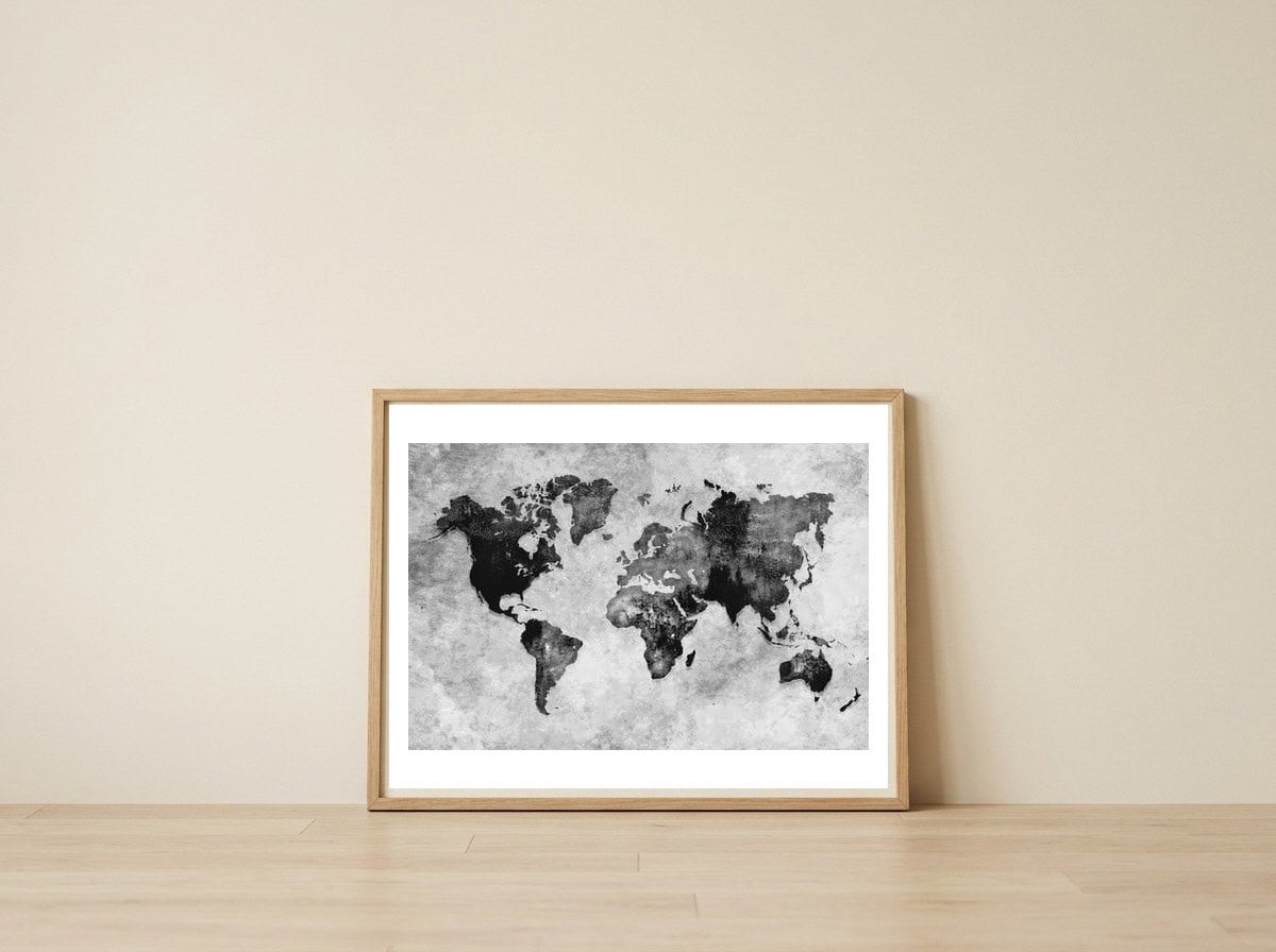 black and white world map — framed, leaning against the wall