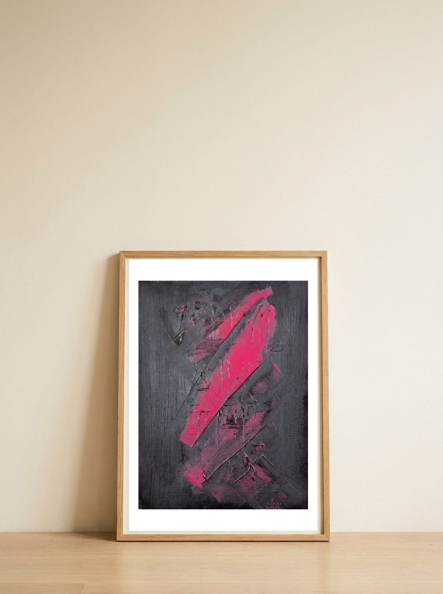 A hint of pink — framed, leaning against the wall