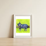 Sleeping cat in purpe — framed, leaning against the wall thumbnail