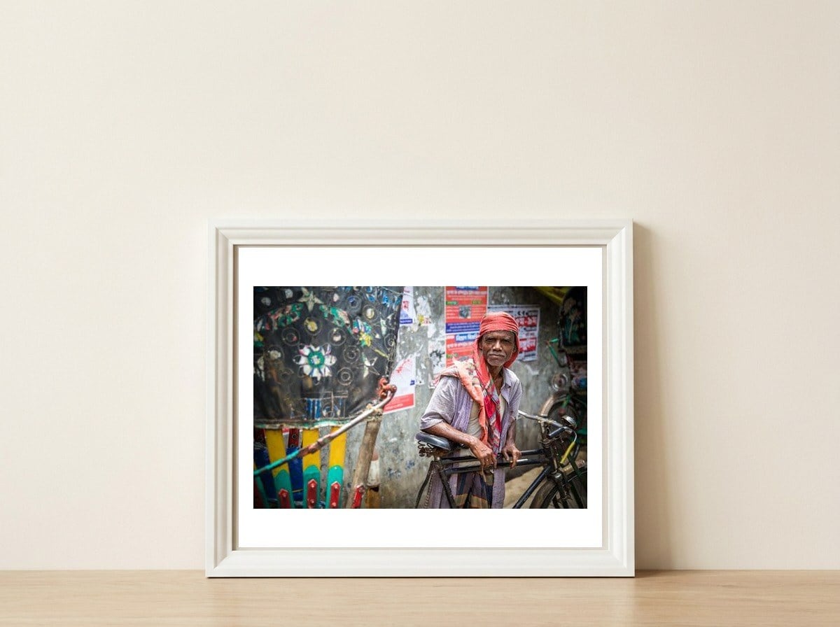 Rickshaw driver  — framed, leaning against the wall