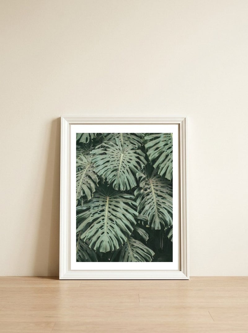 MONSTERA LEAVES — framed, leaning against the wall