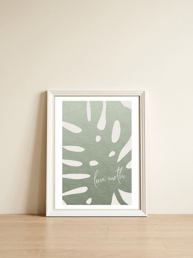 Love earth — framed, leaning against the wall