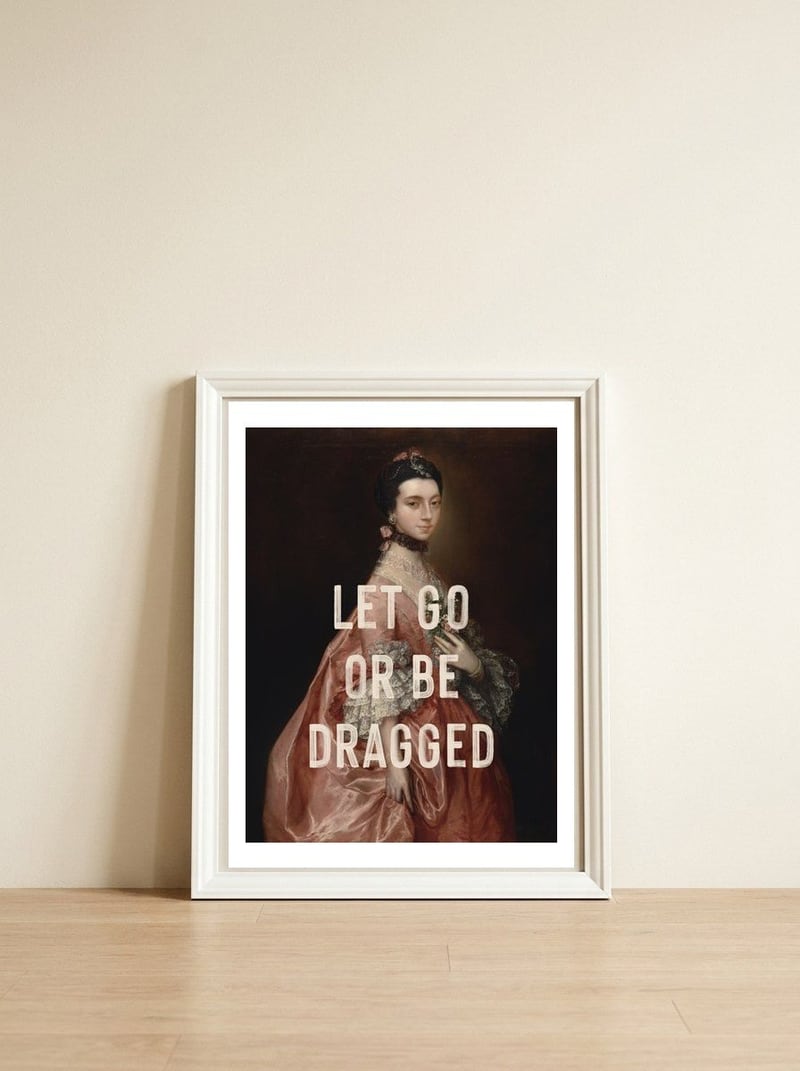 Let Go Or Be Dragged — framed, leaning against the wall