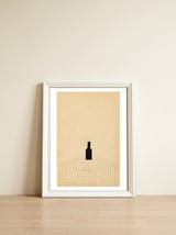 Wine bottle on the table — framed, leaning against the wall thumbnail