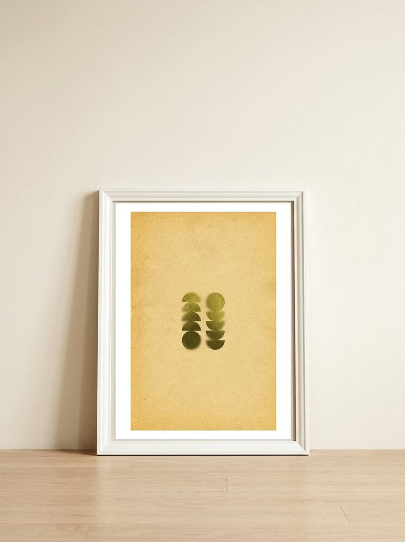 Green blurry geometric shapes — framed, leaning against the wall