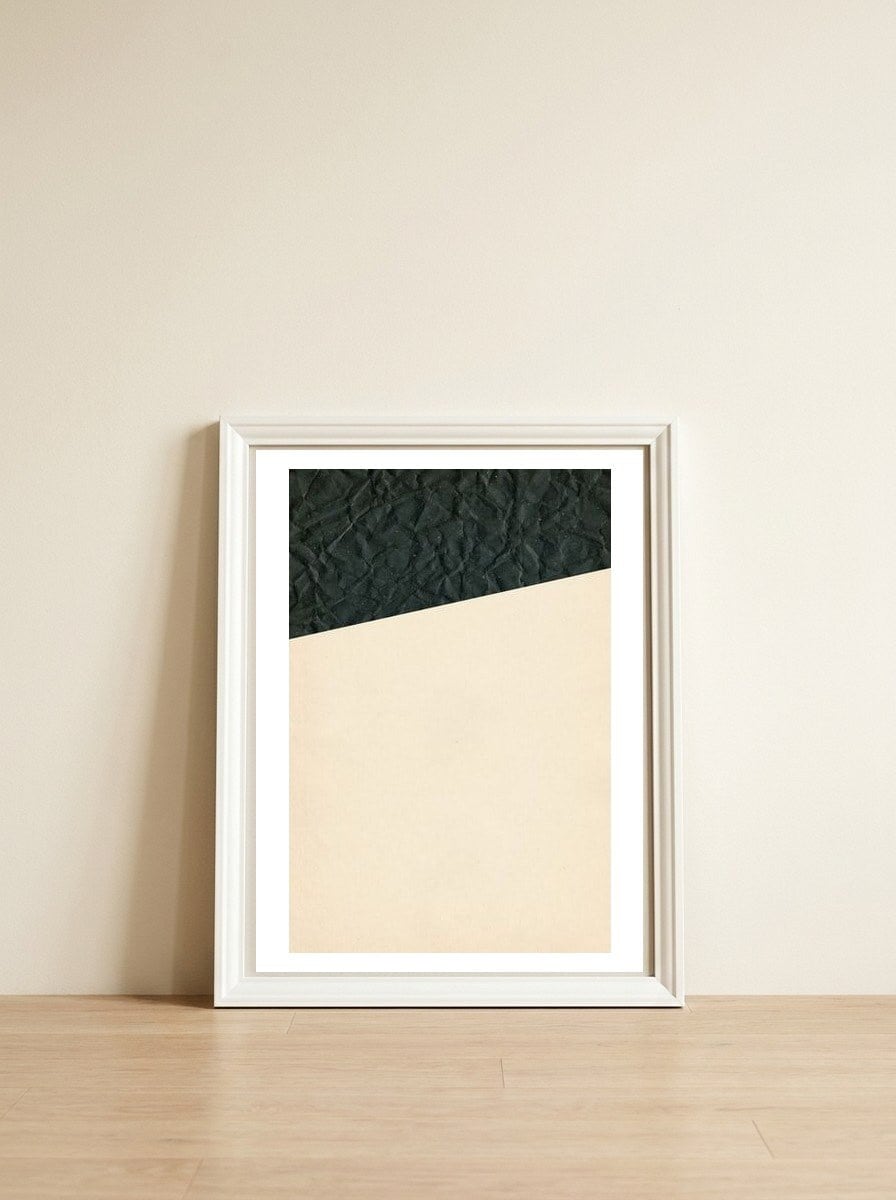 Abstract black paper shape — framed, leaning against the wall