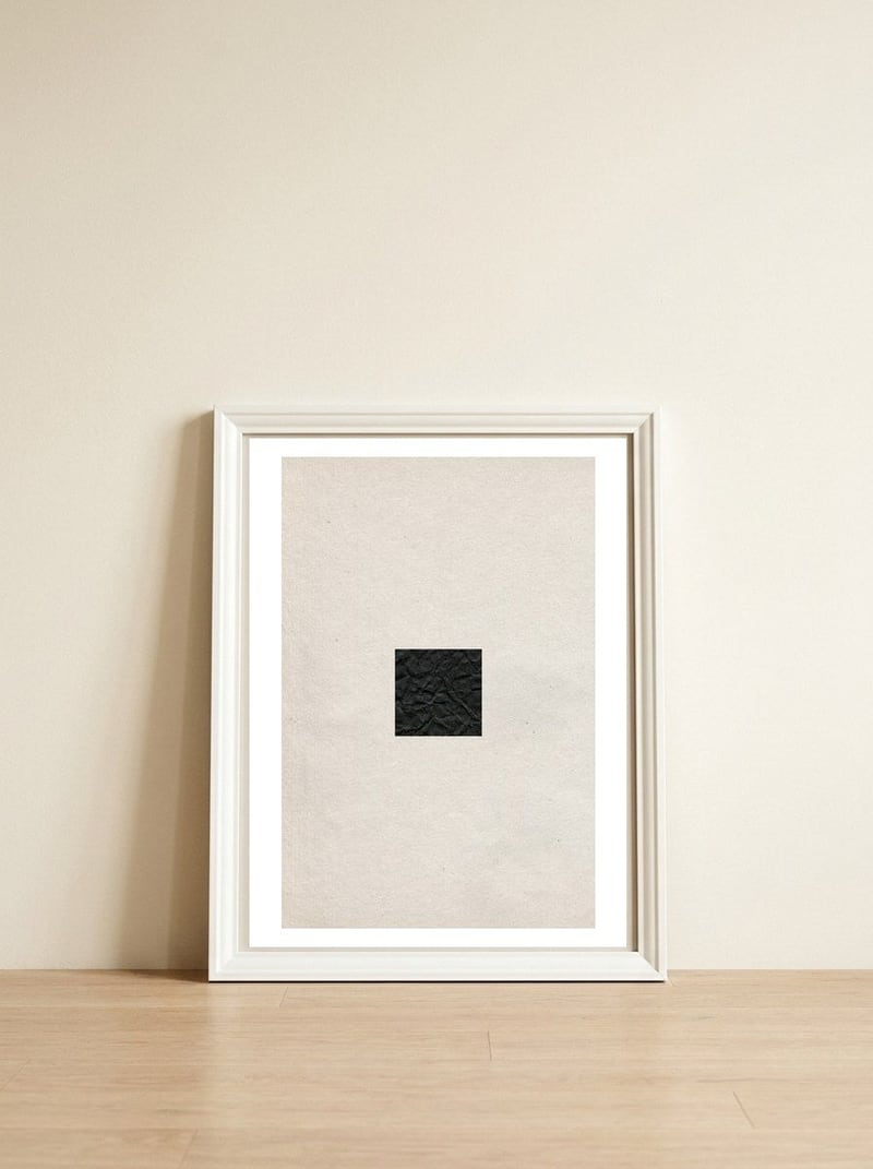 Minimal black square — framed, leaning against the wall
