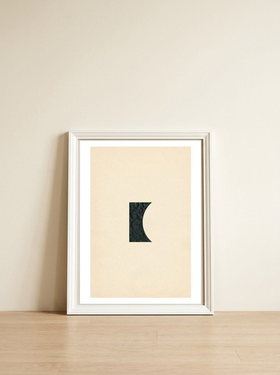 Cut black shape on beige — framed, leaning against the wall