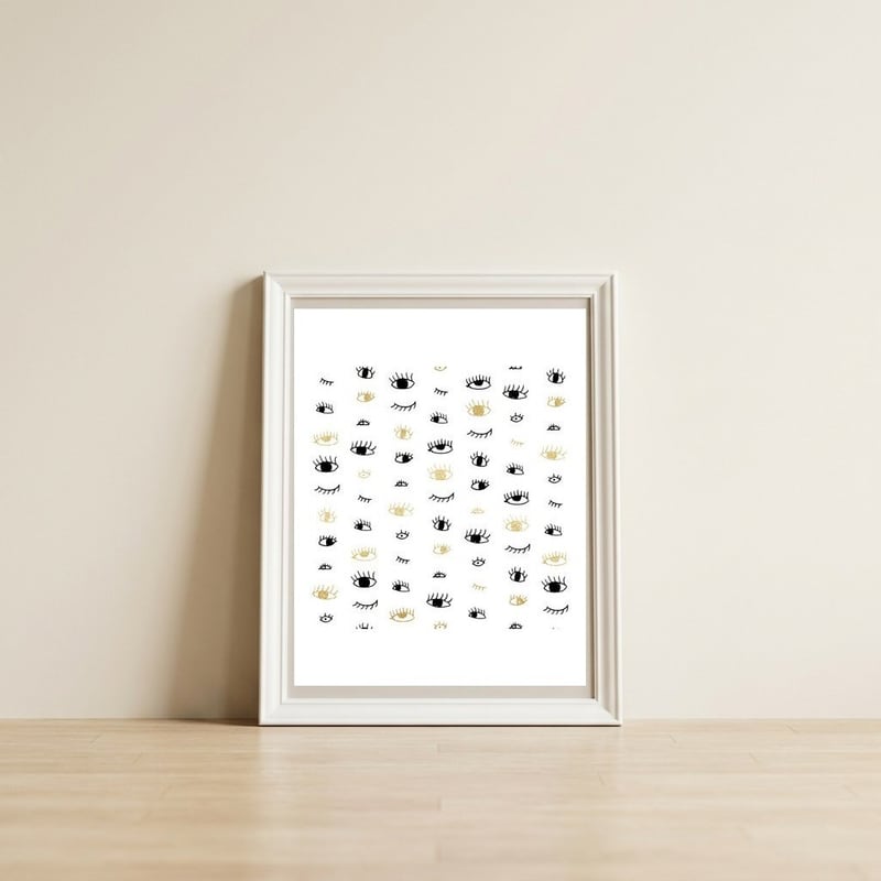 Gold and black eyes and lashes pattern — framed, leaning against the wall