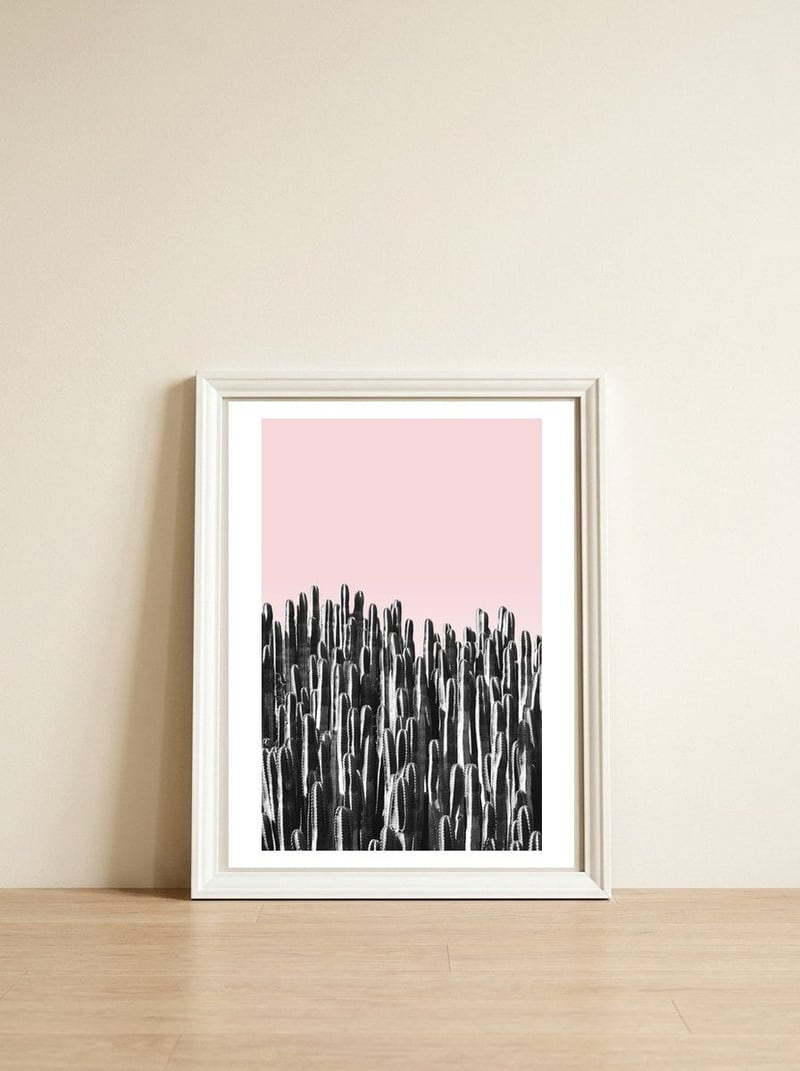 Cactus B&W & Sunset — framed, leaning against the wall