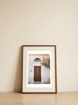 Mediterranean brown wooden door and pink flowers — framed, leaning against the wall thumbnail