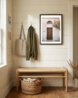 Mediterranean brown wooden door and pink flowers framed in a relaxed room thumbnail