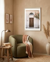 Mediterranean brown wooden door and pink flowers framed in a tender room thumbnail