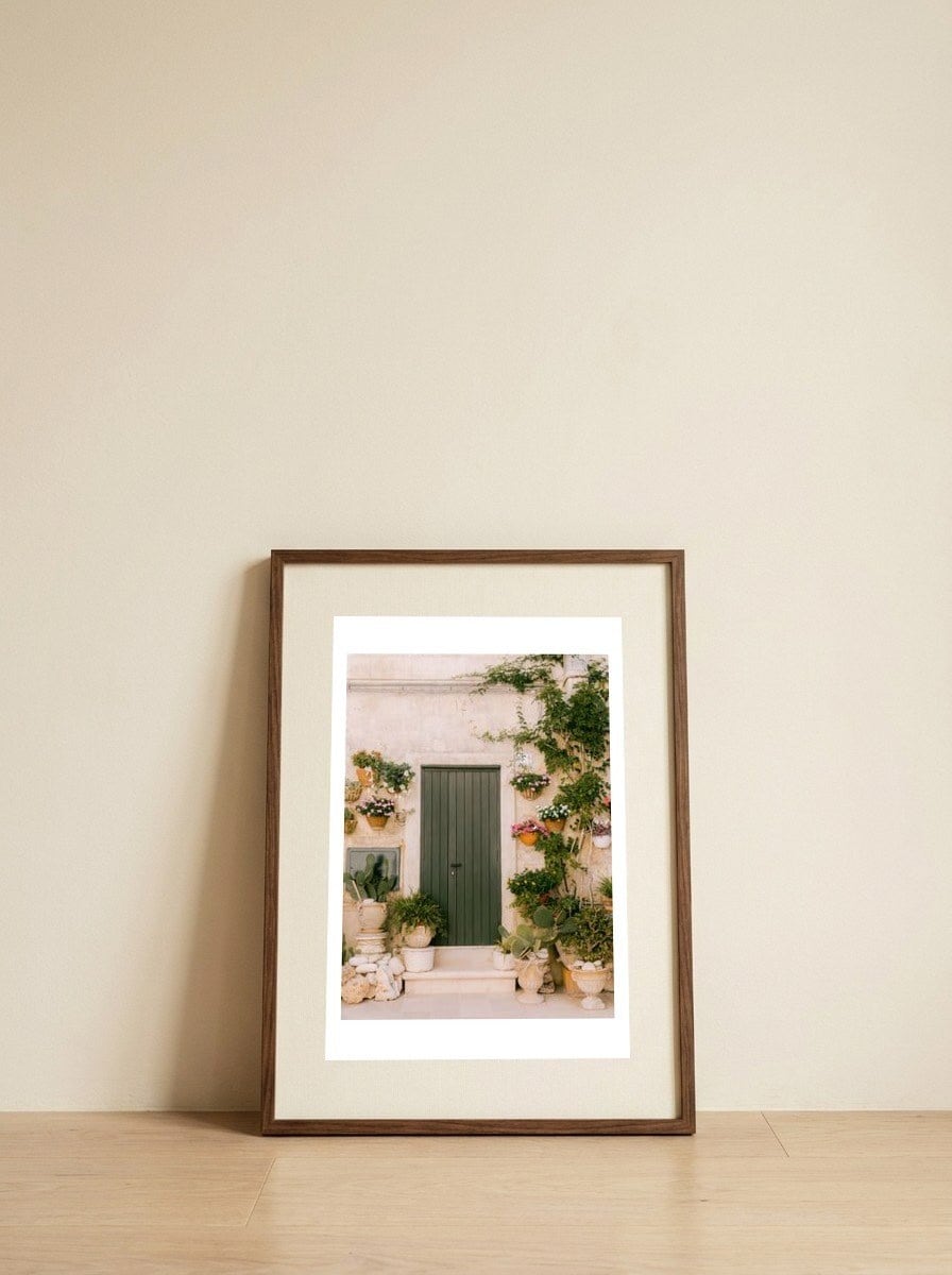 Botanical green door — framed, leaning against the wall