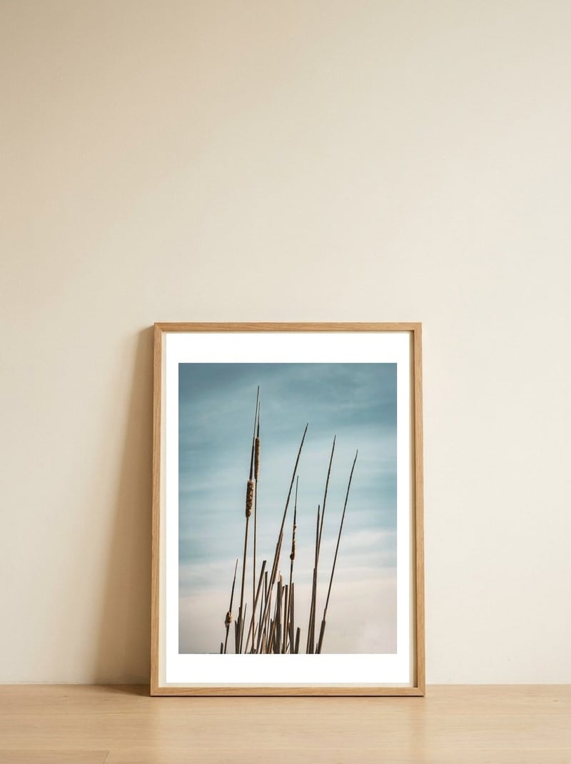 Serene Cattails Blue Sky — framed, leaning against the wall