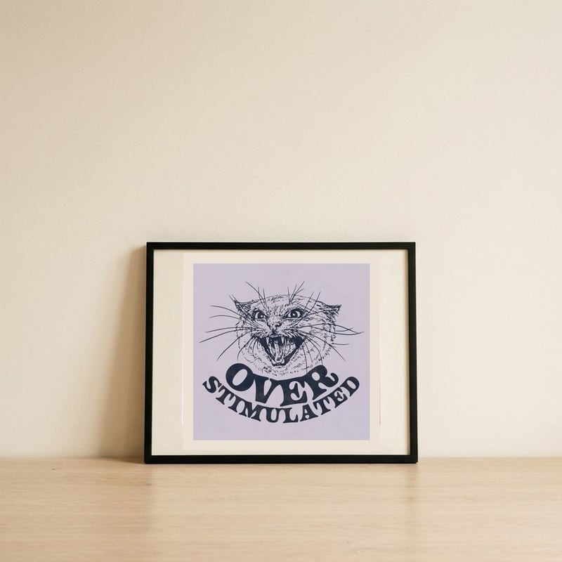 Over Stimulated Cat — framed, leaning against the wall
