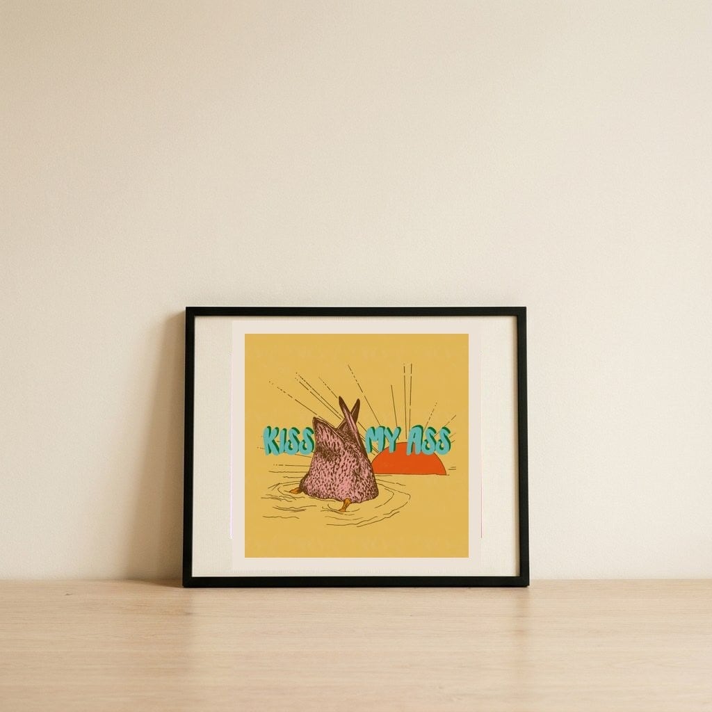 Kiss My Ass Duck — framed, leaning against the wall