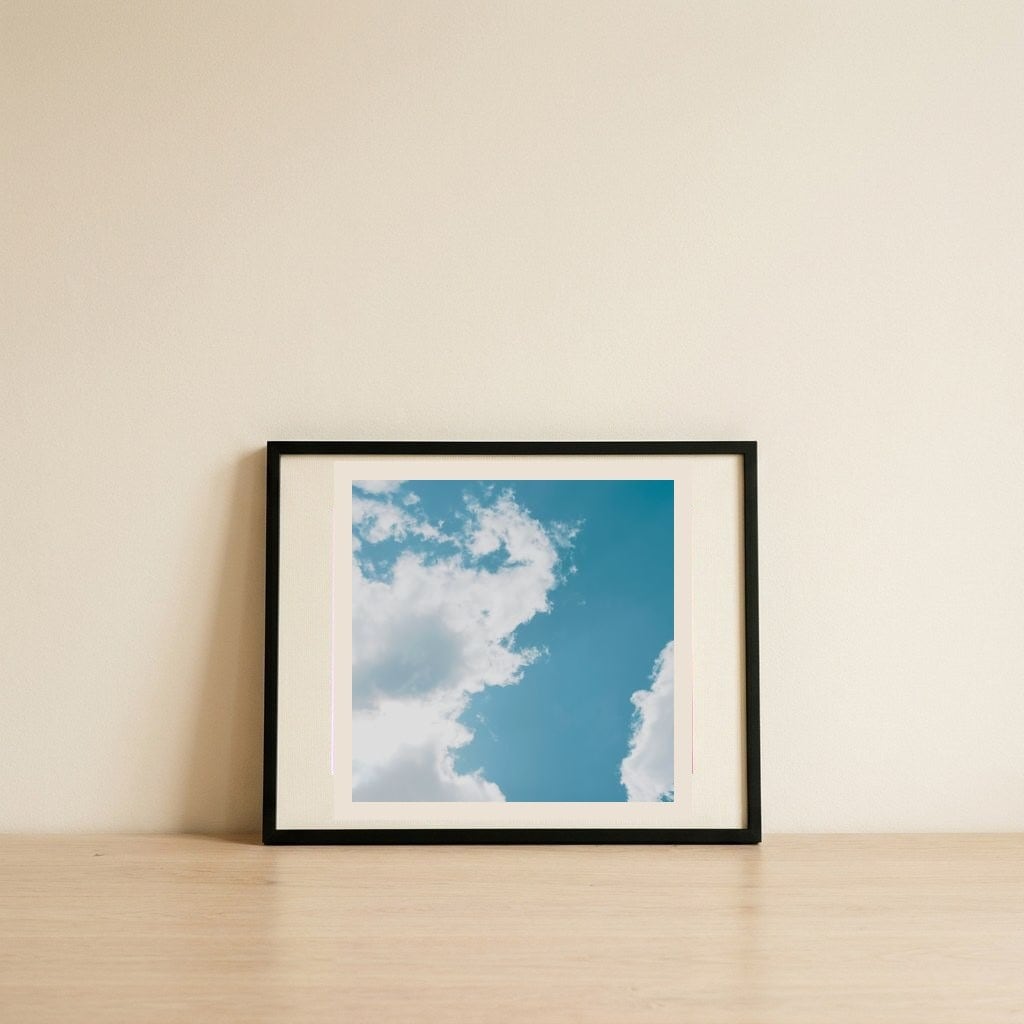 Fluffy Clouds Blue Sky — framed, leaning against the wall