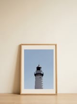 Lighthouse Under Blue Sky — framed, leaning against the wall thumbnail