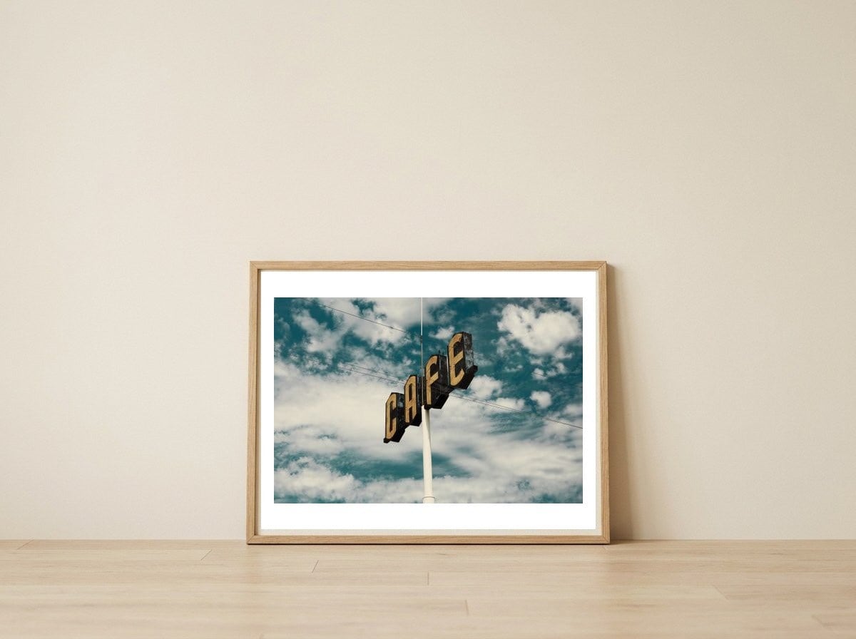 CAFE — framed, leaning against the wall