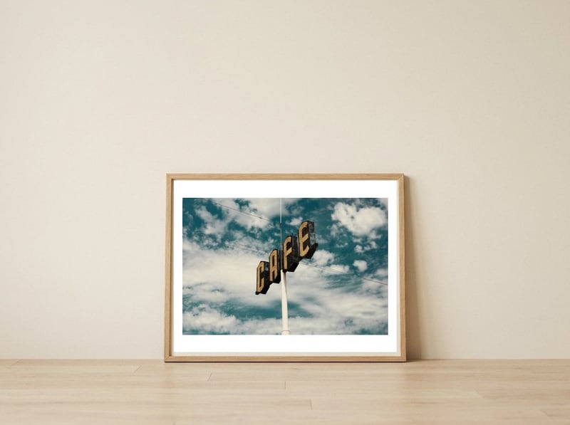 CAFE — framed, leaning against the wall