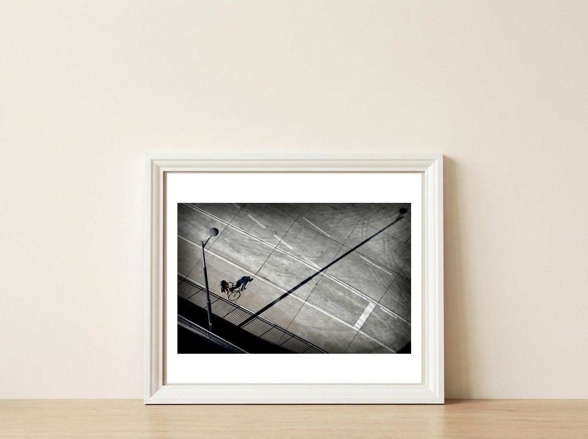 Cyclist — framed, leaning against the wall