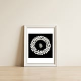 White pearls and stone — framed, leaning against the wall thumbnail