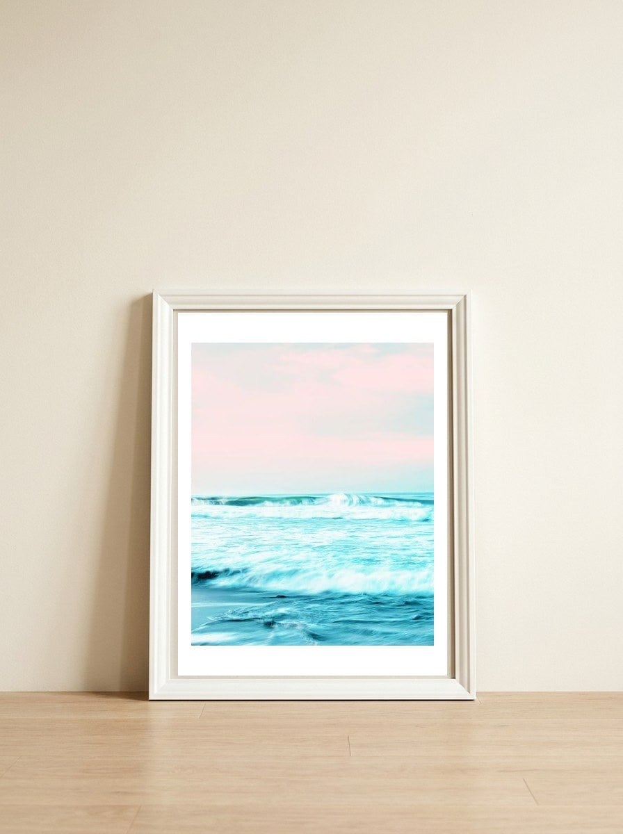Sun. Sand. Sea. — framed, leaning against the wall