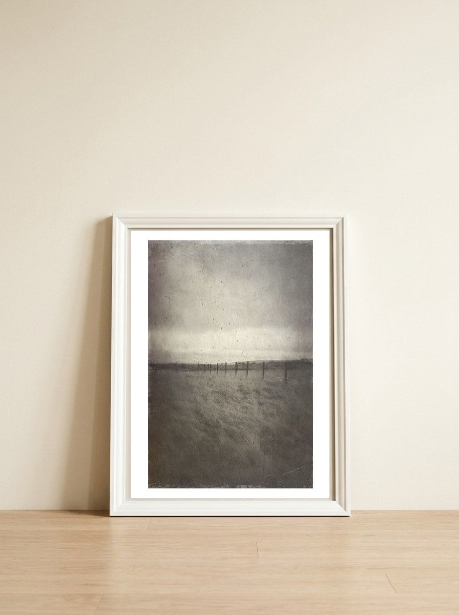 Bleak winter landscape of Saddleworth Moor — framed, leaning against the wall
